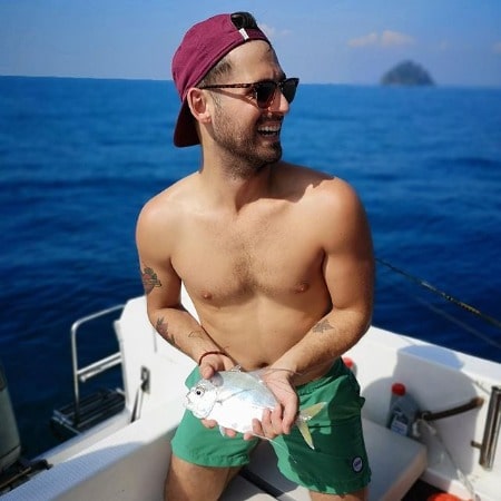 A smiling picture of Jean-Luc Bilodeau enjoying in an ocean 